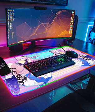 gaming desk setup with anime RGB mouse pad featuring Citlali hugging Aether and Lumine plushies